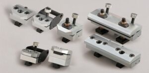 Use Ledge Clamps (Fixed Clamp Height Rocker Clamps) with dies having a clamp plate that sticks out from the die body or has a large slot.
