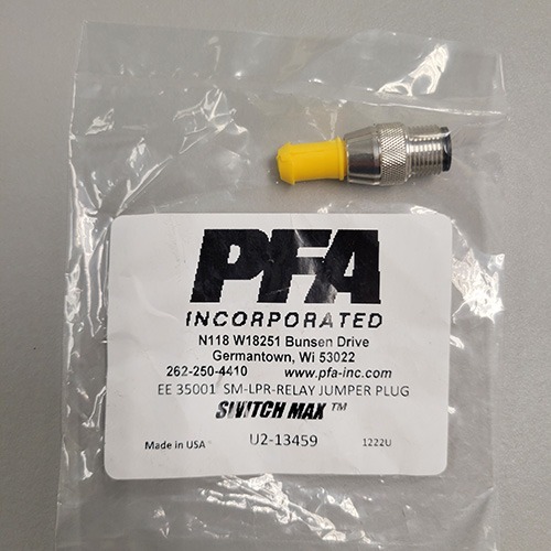 A small sealed plastic bag containing a single metallic relay jumper plug and a label from PFA Incorporated for SWITCHMAX™ products.