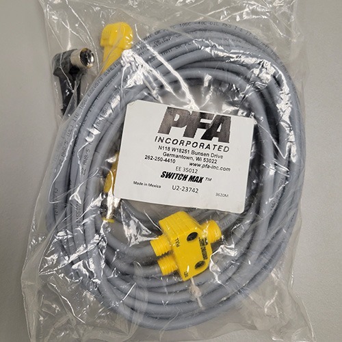 A packaged grey Ethernet cable with a yellow RJ45 connector and an attached label from PFA Incorporated, indicating it is part of the SWITCHMAX™ system.