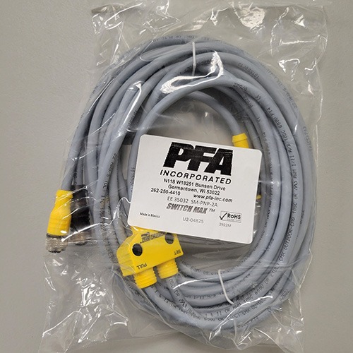 A packaged grey Ethernet cable with a yellow RJ45 connector and an attached label from PFA Incorporated, indicating it is part of the SWITCHMAX™ system.