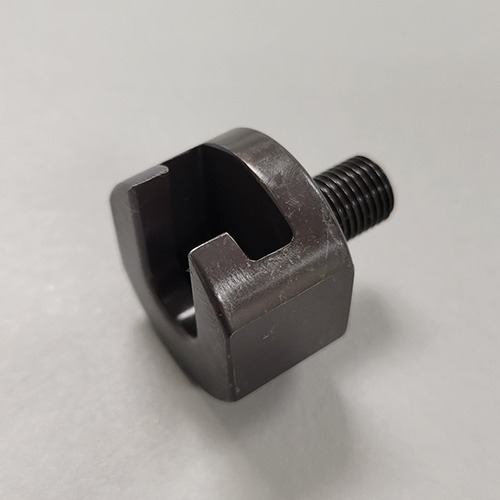 A specialized metal tool with a threaded shaft and a slotted end, designed for a mechanical application, on a grey background.