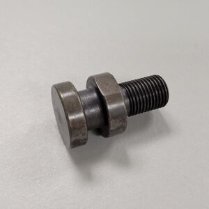 A metal assembly consisting of a large bolt, two washers, and a black rubber element, possibly a vibration damper, on a grey surface.