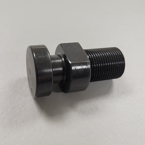 A metal assembly consisting of a large bolt, two washers, and a black rubber element, possibly a vibration damper, on a grey surface