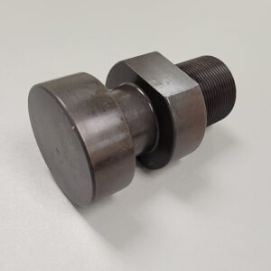 A metal assembly consisting of a large bolt, two washers, and a black rubber element, possibly a vibration damper, on a grey surface.