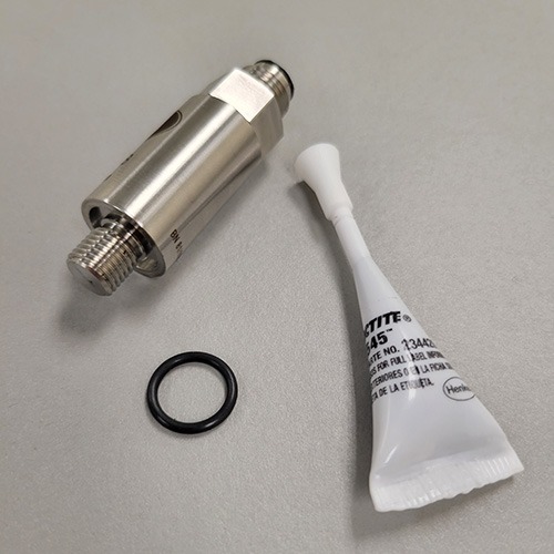 A metallic cylinder with sensor threads, a black O-ring, and a squeezed tube of Loctite thread sealant against a light grey background.