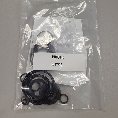 A mix of mechanical O-rings and seals in a transparent plastic bag, with part number 'PH05040' and the date '5/17/22'.