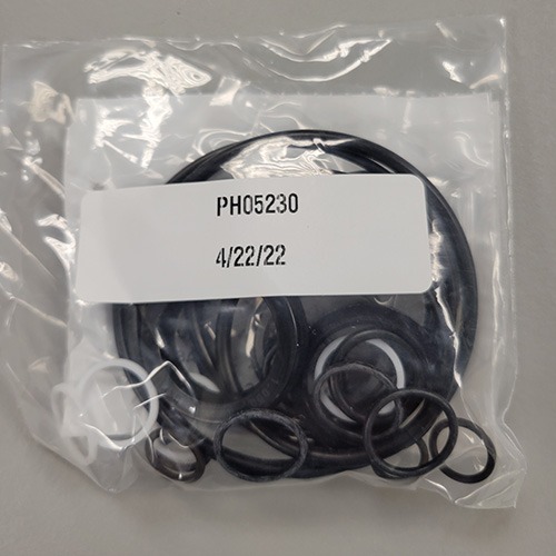 Multiple sizes of mechanical O-rings and seals in a plastic bag, marked with part number 'PH05230' and a packing date of '4/22/22'.