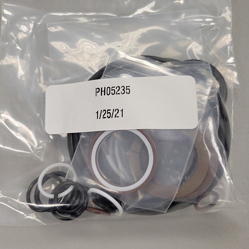 An assortment of mechanical O-rings and seals in a transparent plastic bag, tagged with part number 'PH05235' and a date of '1/25/21'.