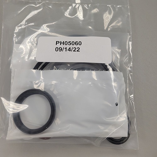 Various mechanical O-rings and seals in a clear plastic bag, with a label indicating part number 'PH05060' and the date '09/14/22'.