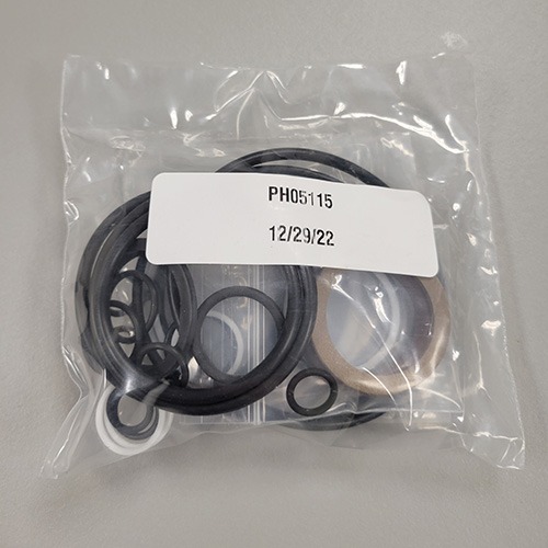 A collection of mechanical O-rings and seals in a clear plastic bag, labeled with part number 'PH05115' and a packing date of '12/29/22'.