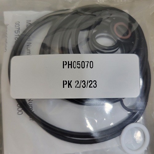 Assorted mechanical O-rings and seals in a plastic bag, with part number 'PH05070' and the date '2/3/23' on the attached label.